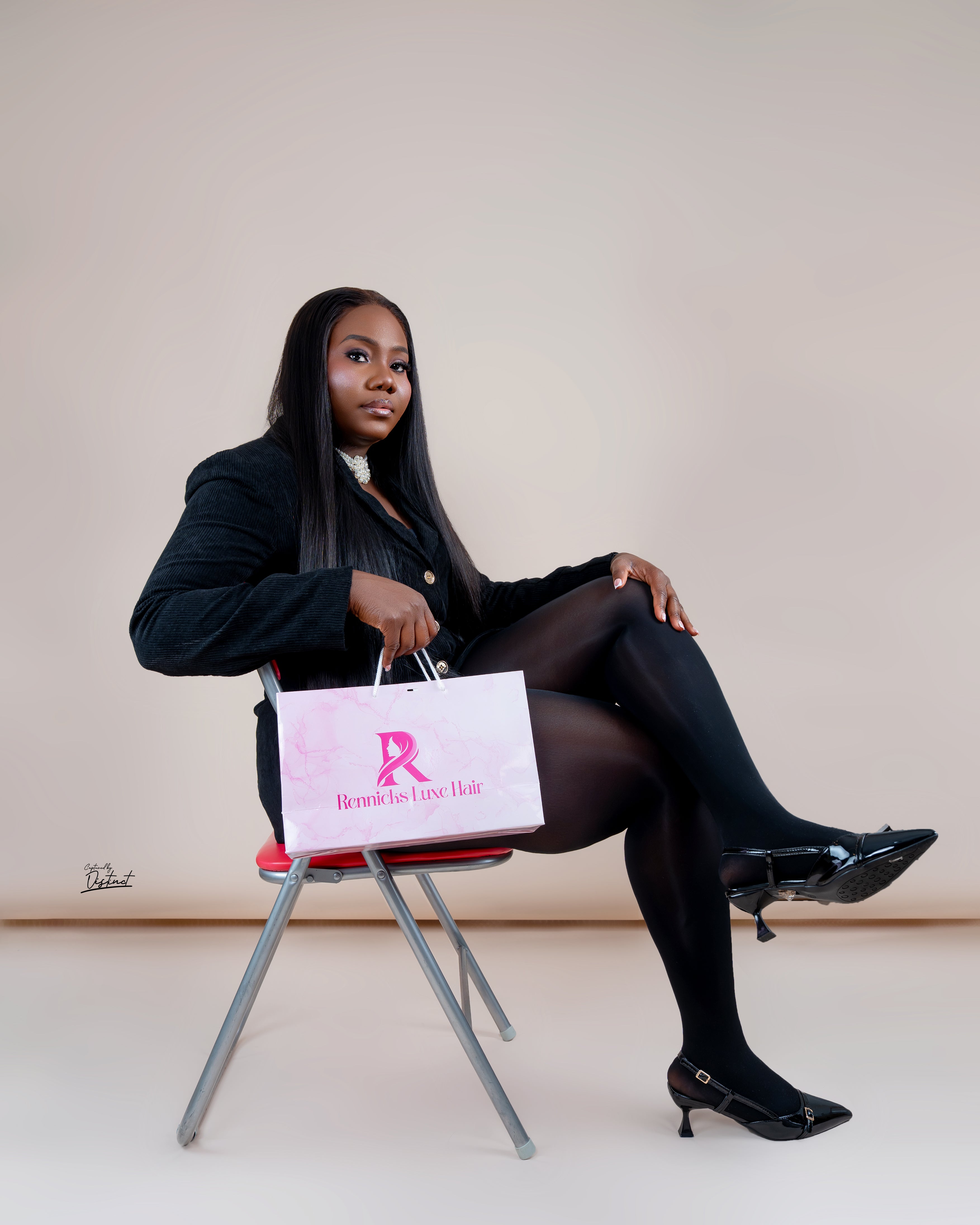 Rennicks Luxe Hair model holding branded shopping bag